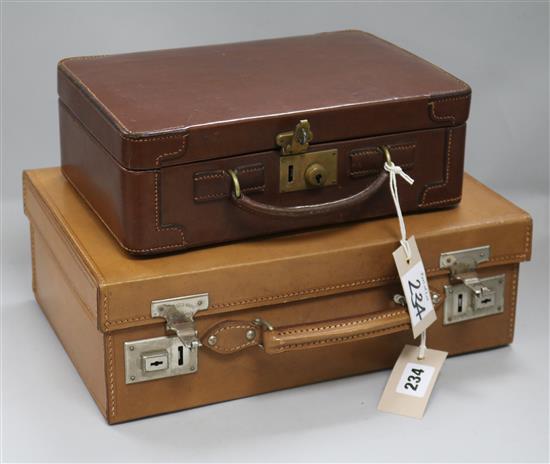 A leather-cased fitted dressing case, early 20th century, a similar smaller fitted case, both in good condition